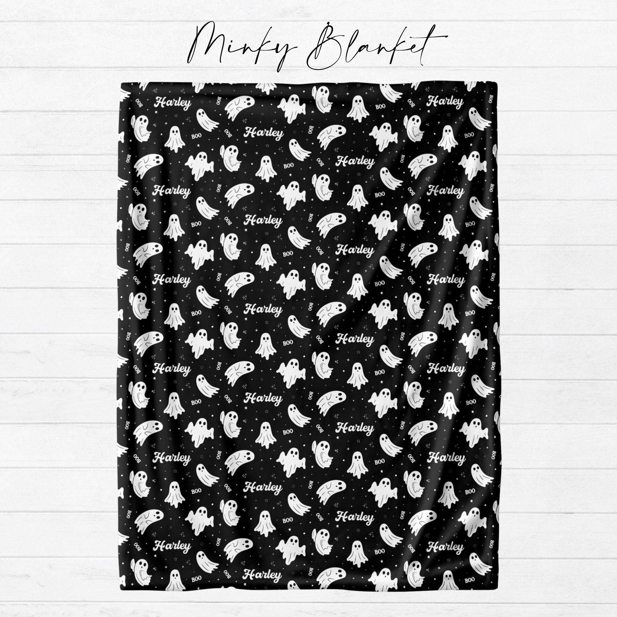 Personalized black ghost Halloween minky blanket with custom name shown flat from Twinklette