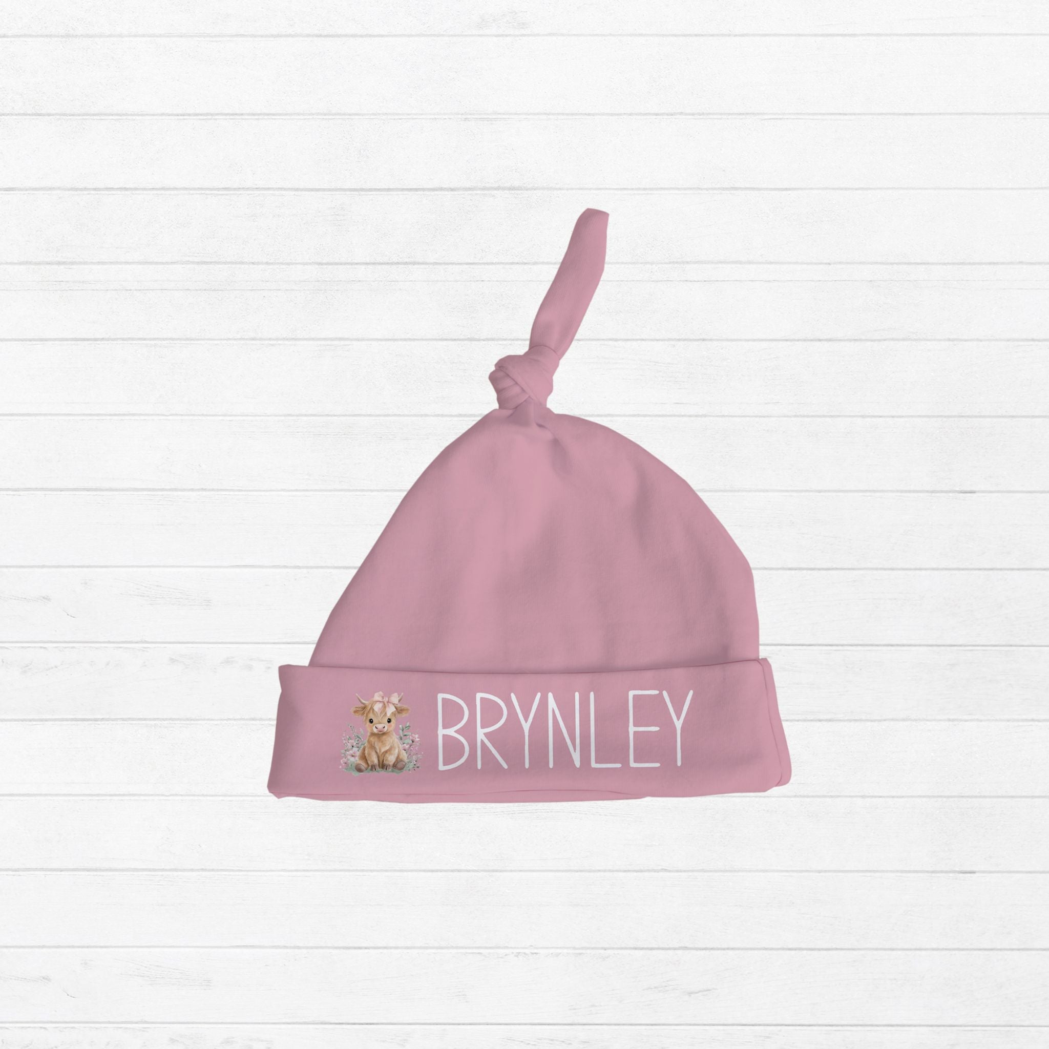 Personalized pink knotted newborn hat with Highland Cow design and baby name