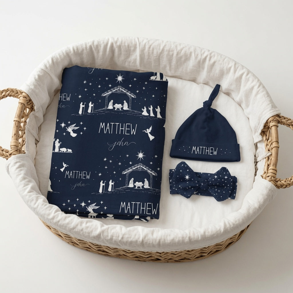 Personalized nativity baby matching set with custom name swaddle blanket, knotted hat, and bow headband in Night Sky navy