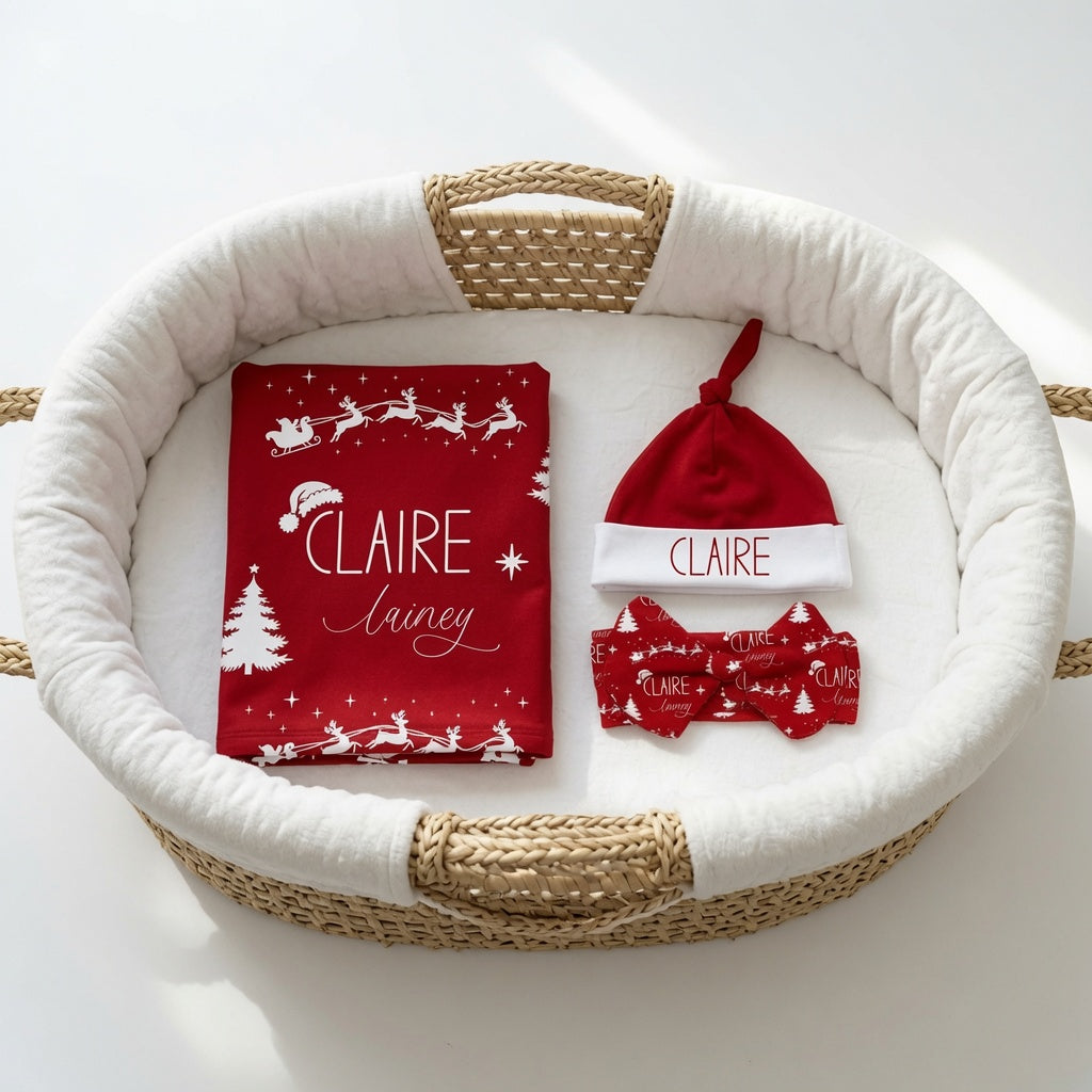 Personalized Santa's sleigh baby matching set with custom name swaddle blanket, knotted hat, and bow headband in Crimson Holly red
